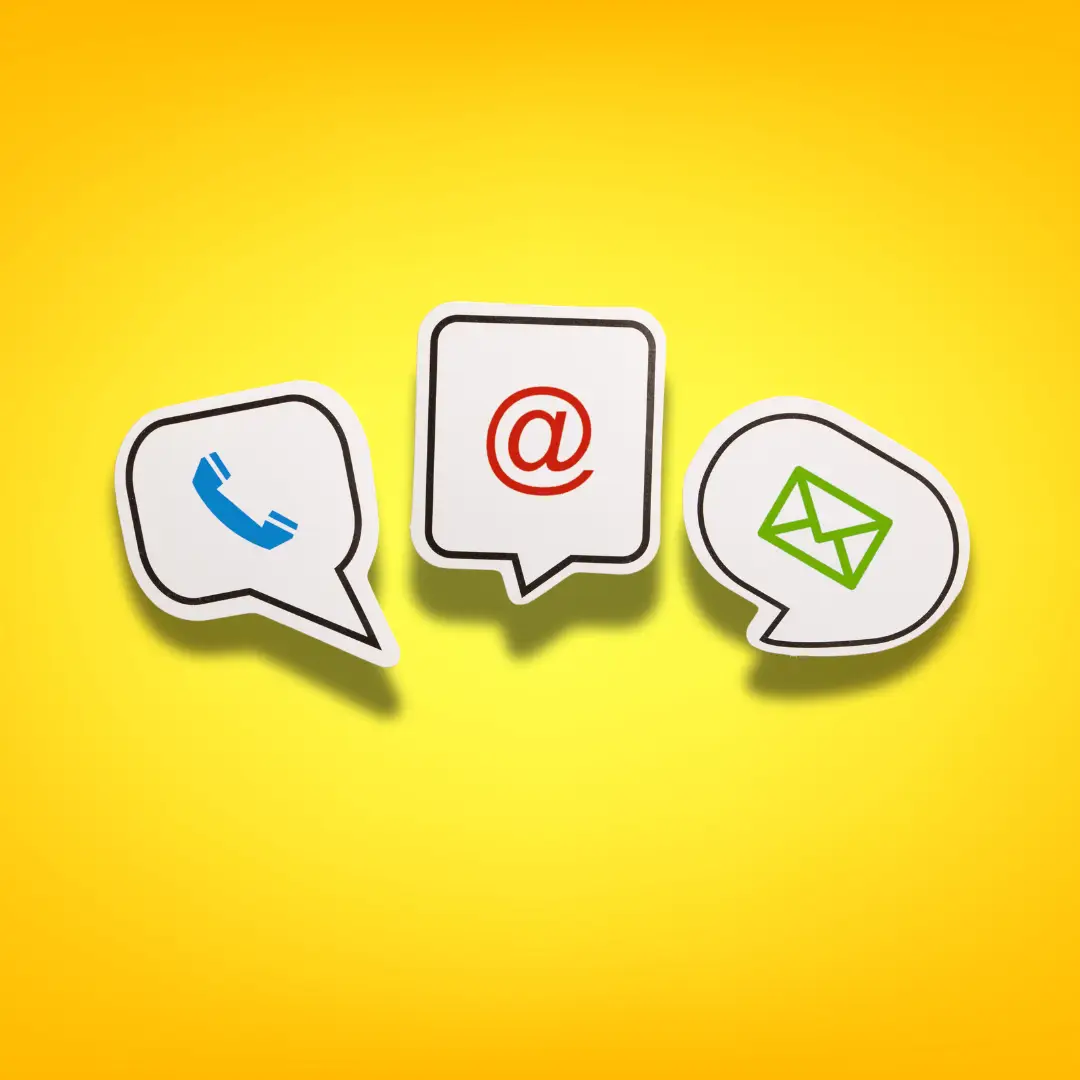 Icons for phone, email, and message communication on a bright yellow background, representing ways to contact us.