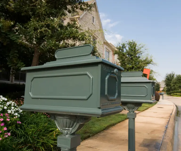 Row of decorative residential mailboxes in a suburban neighborhood, representing direct mail delivery to local homes.